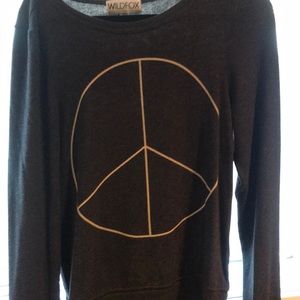 Dark gray sweater with white piece sign in middle